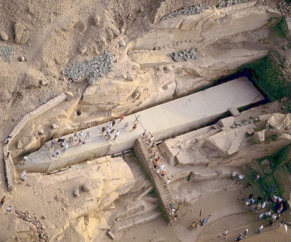 Aerial view of the Unfinished Obelisk with tourists exploring the ancient quarry site.