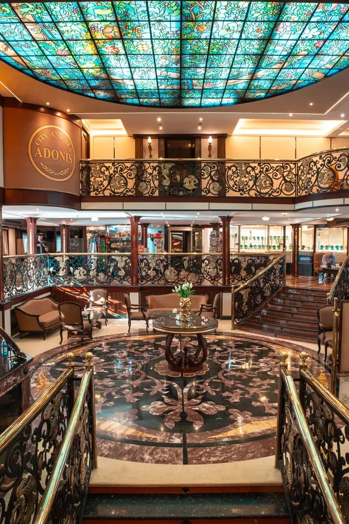 The grand atrium and its stained-glass dome aboard the M/S City and Sea Adonis
