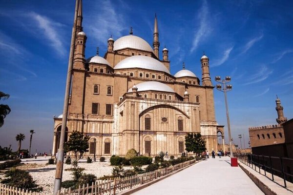 Muhammad Ali Mosque in Cairo with multiple domes and minarets against blue sky