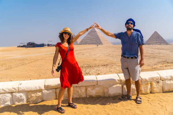 Tourist couple at the Pyramids of Giza in Cairo, Egypt